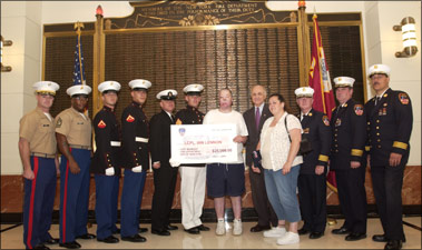 On Thursday, July 1, 2004, Fire Commissioner Nicholas Scoppetta presented Lance Corporal Ian Lennon with a check on behalf of the members of the FDNY.