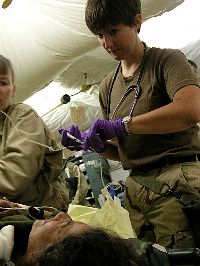 Ensign Jill Skeet from Williamsburg, Kan., administers pain medication to an unidentified Iraqi woman who arrived in Fleet Hospital Three’s (FH-3) Casualty Receiving room with a gunshot wound